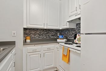 Kitchen with white cabinetry and appliances